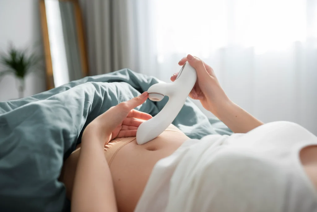 Girl using sex toy on the bed