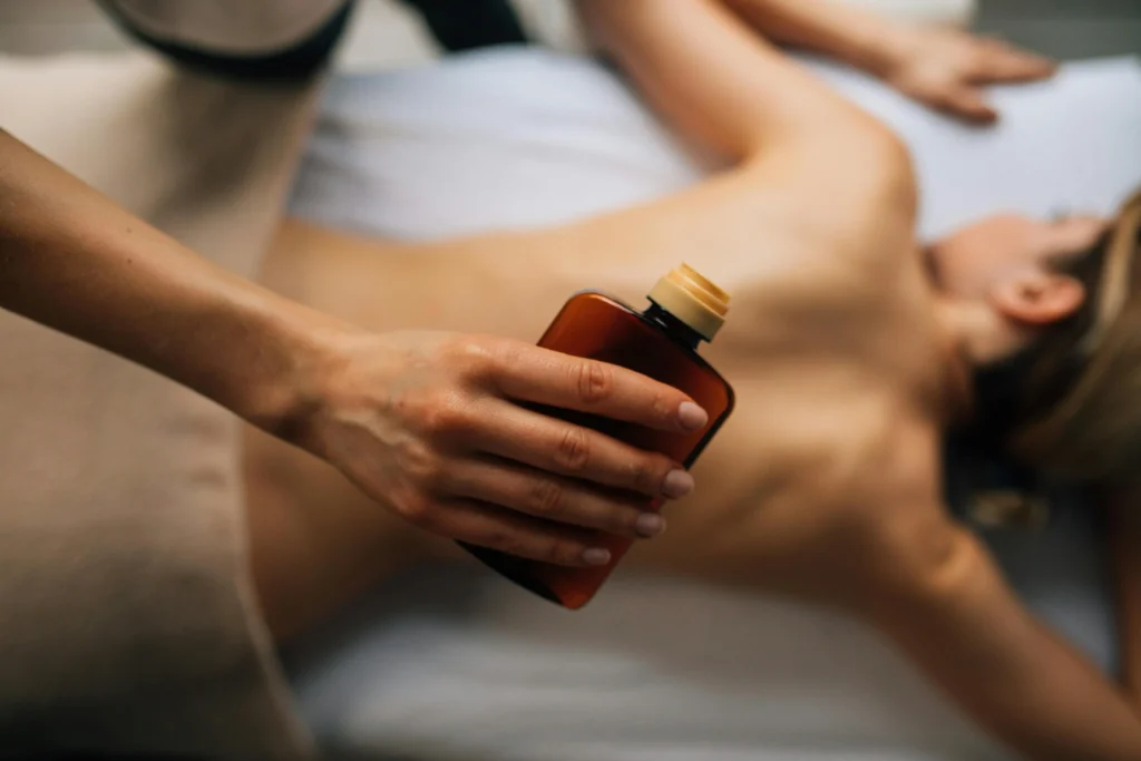 A Person Holding a Bottle with start Sensual Massage