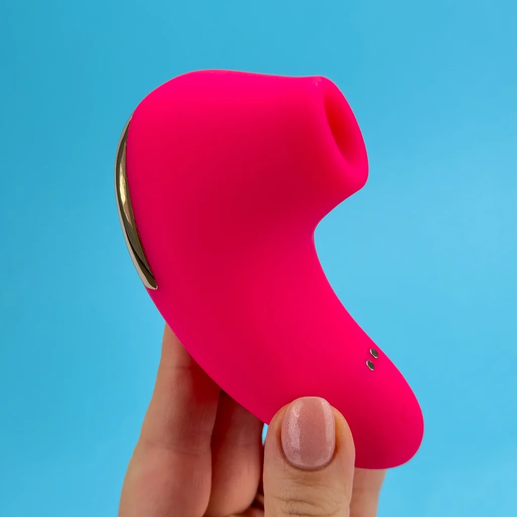 Women holding red color Ada clit suction vibrator