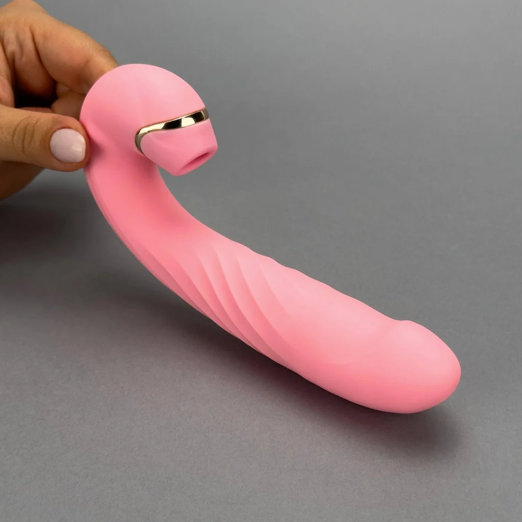 Women holding pink color swish clit suction toy