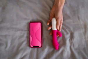 Flat lay of the 5 best clit suction toys of 2025 on a pink background, showcasing luxury designs, waterproof features, and feminine aesthetics
