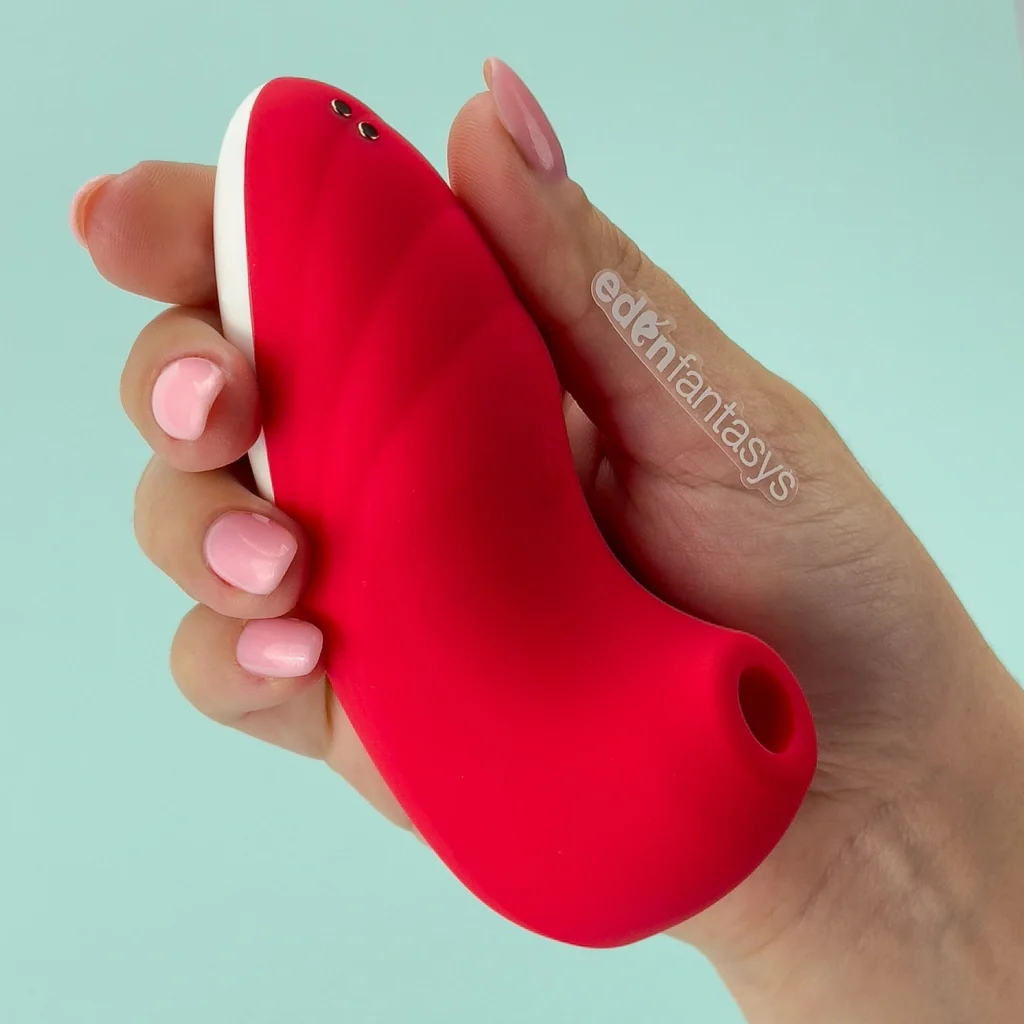 Women holding a red color Air caress clitoral suction