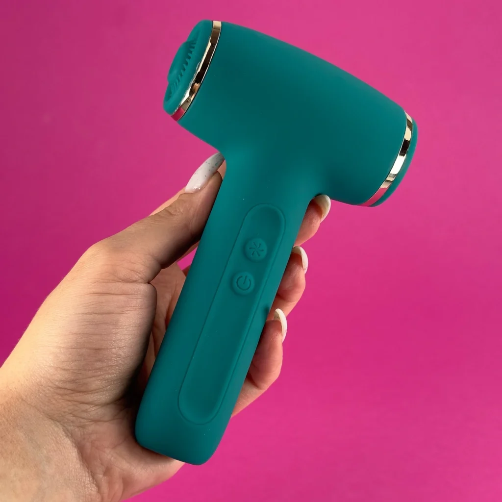 Image showing a women holding green color Dual treat clitoral suction