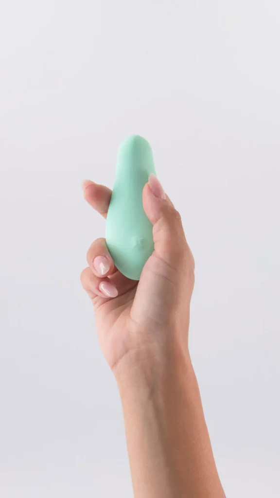 A hand hold a Palm mini massager