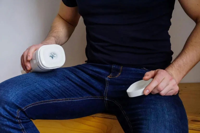 A man holding one of the best automatic suction toys for men while relaxing in bed, exploring modern pleasure technology.
