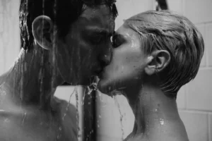 Romantic couple kissing in the shower while exploring intimacy with waterproof couple vibrators for shower play.